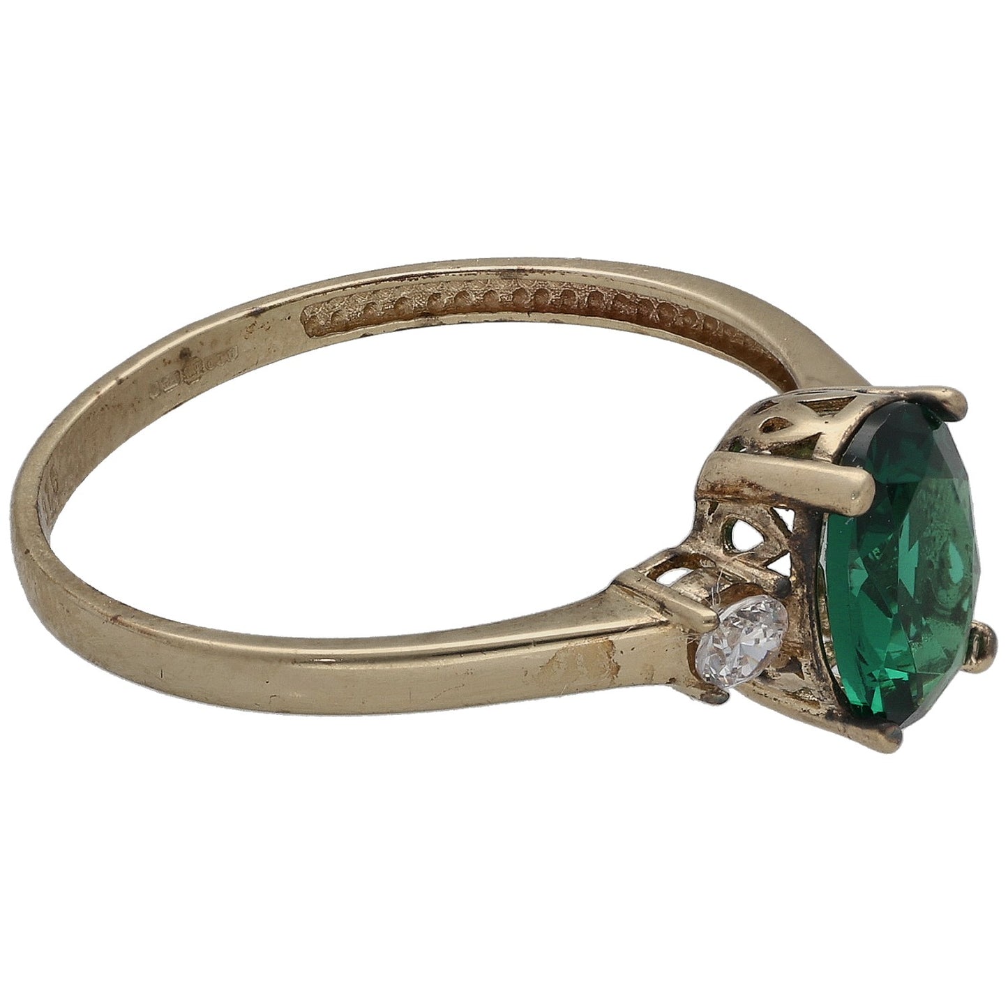 Gold-tone ring side view with green oval center stone and one clear round accent
