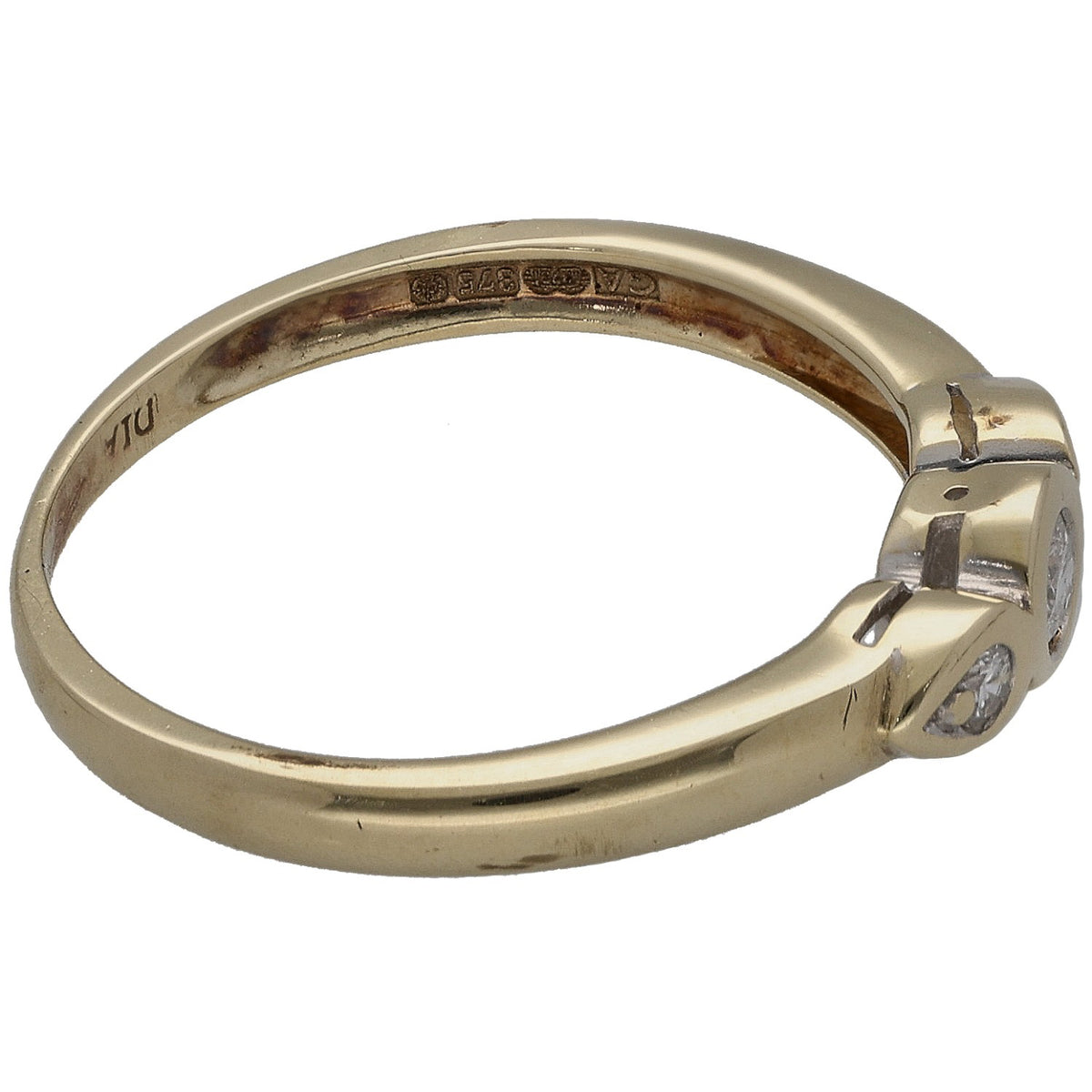 Round diamond three-stone ring in 9ct gold, side profile with engraved hallmarks