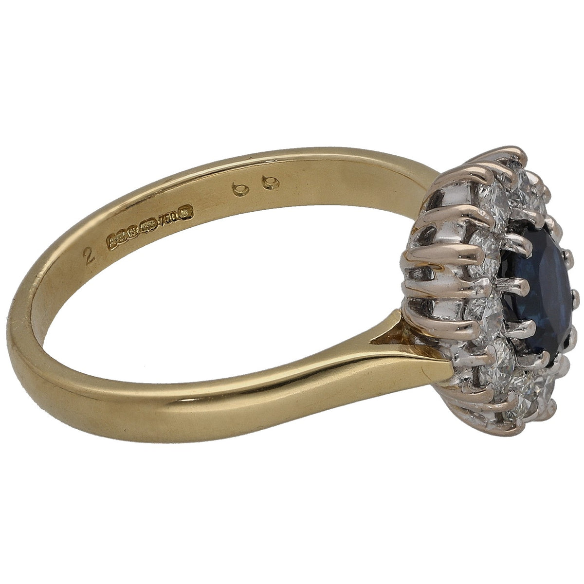 Gold ring with round sapphire setting and side view of diamond halo