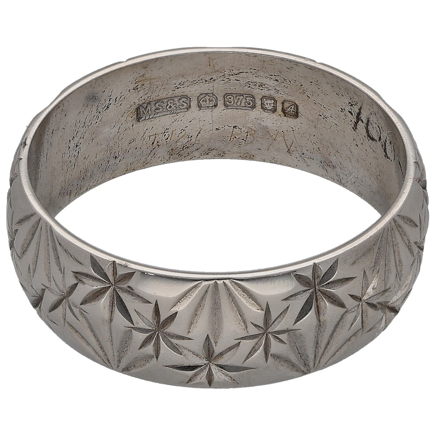 White gold wedding ring with engraved markings inside and star pattern on band