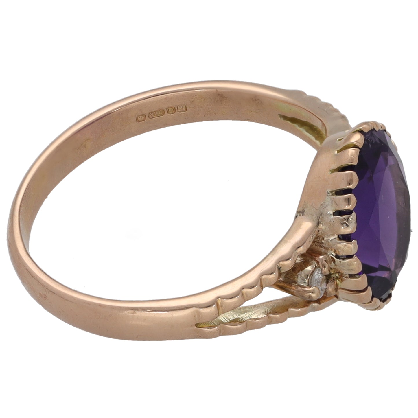 Rose gold tone ring band with dark purple oval stone and scalloped setting detail