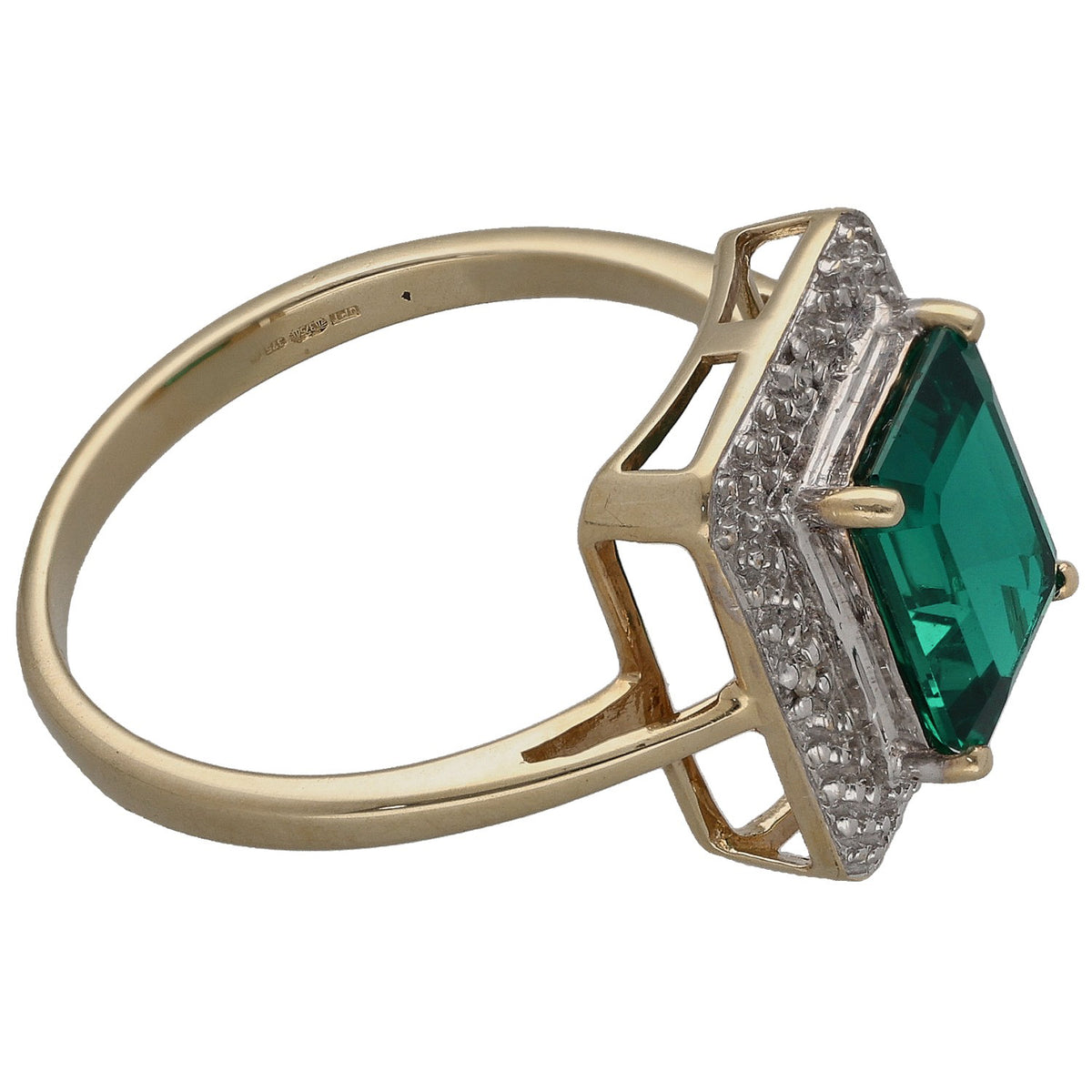 Gold ring side view with green emerald cushion stone, diamond pave border