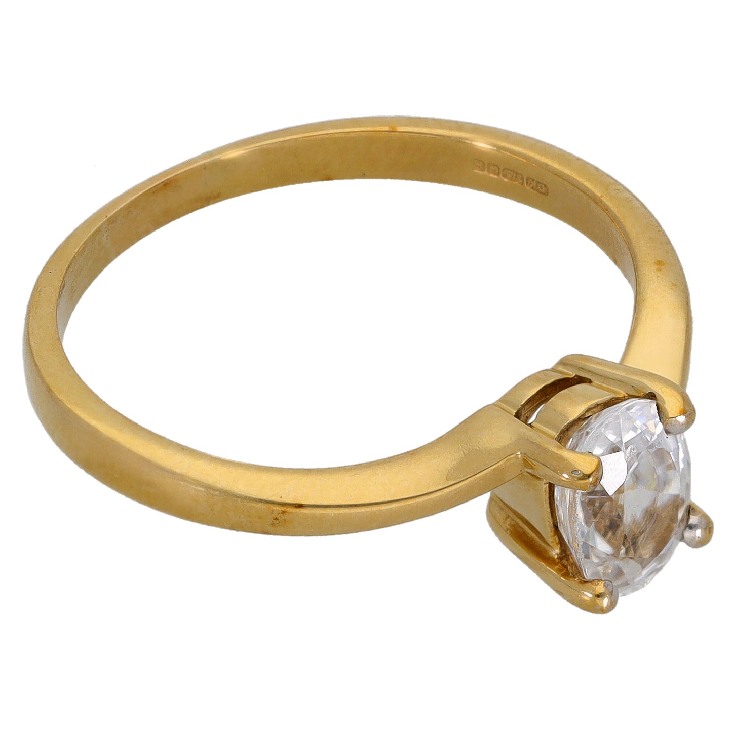 Gold band ring with large clear cushion-cut stone set low in four-prong setting.