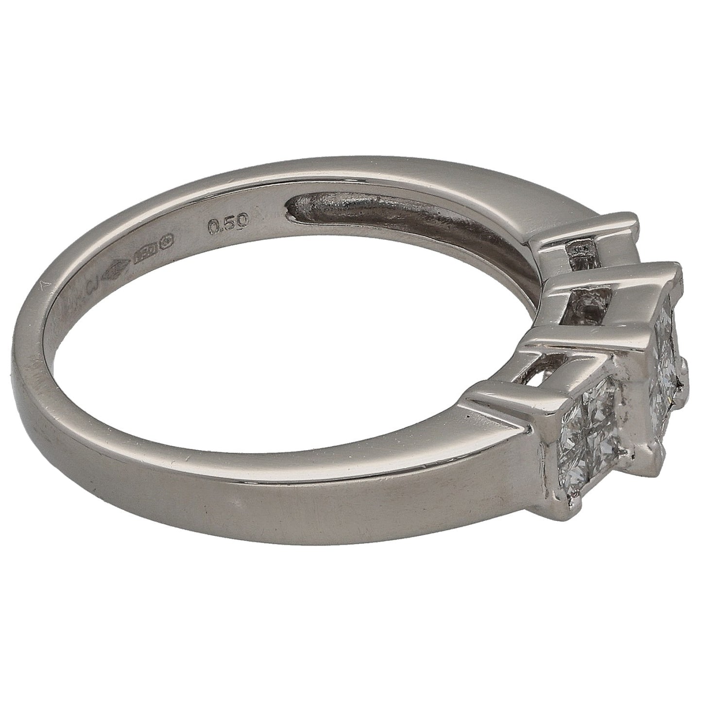 Platinum ring with square diamond cluster and setting prongs, side profile view.