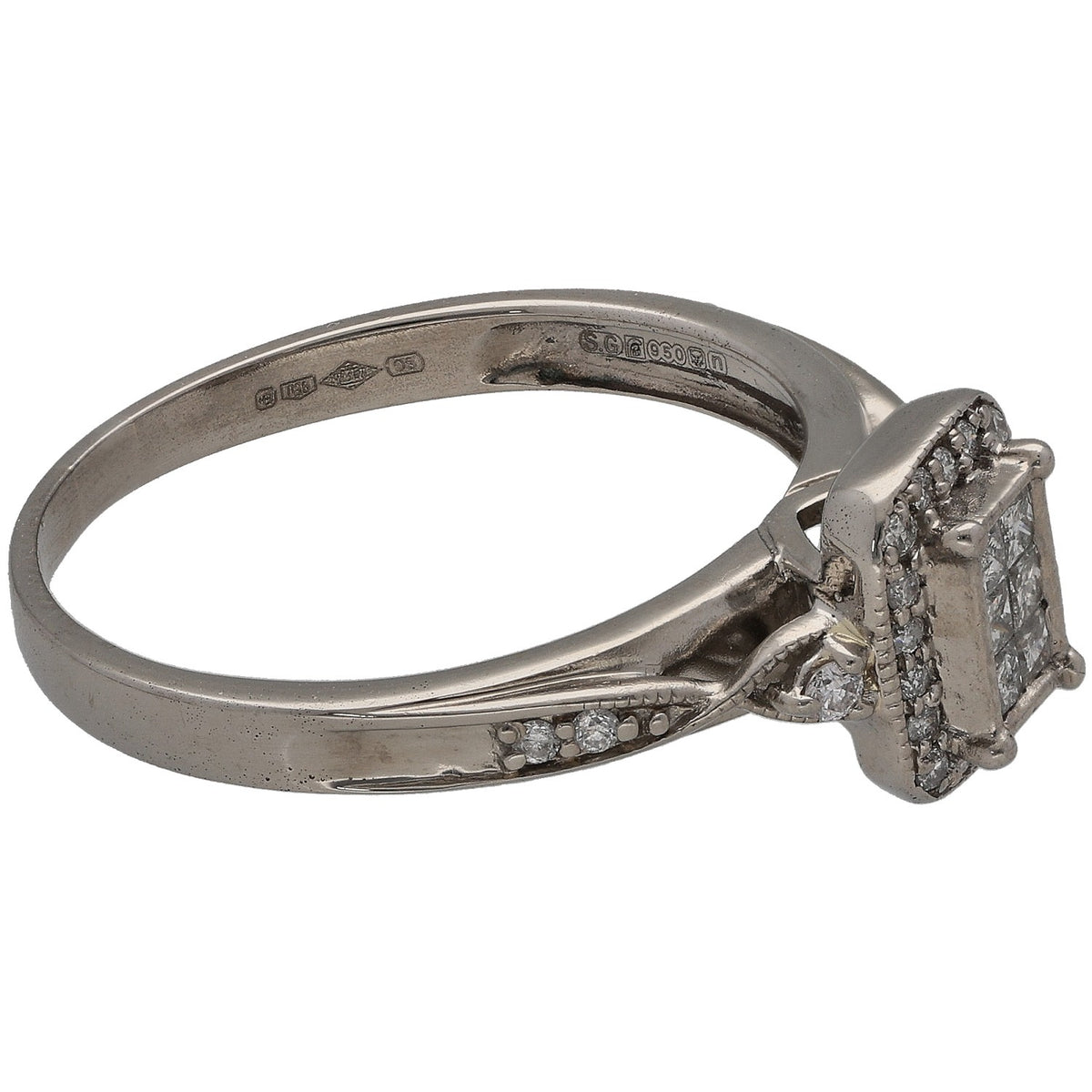 Platinum diamond cluster ring side view with engraved band and prong-set halo