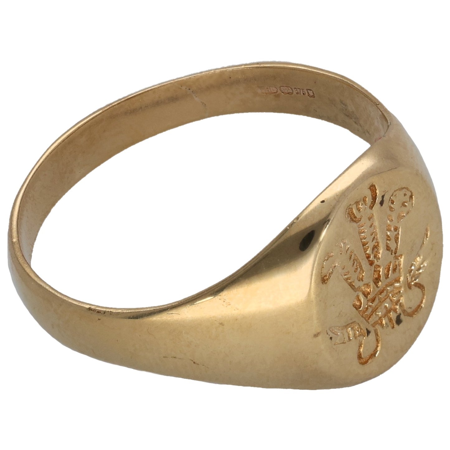 Gold-tone ring with engraved emblem detail on side