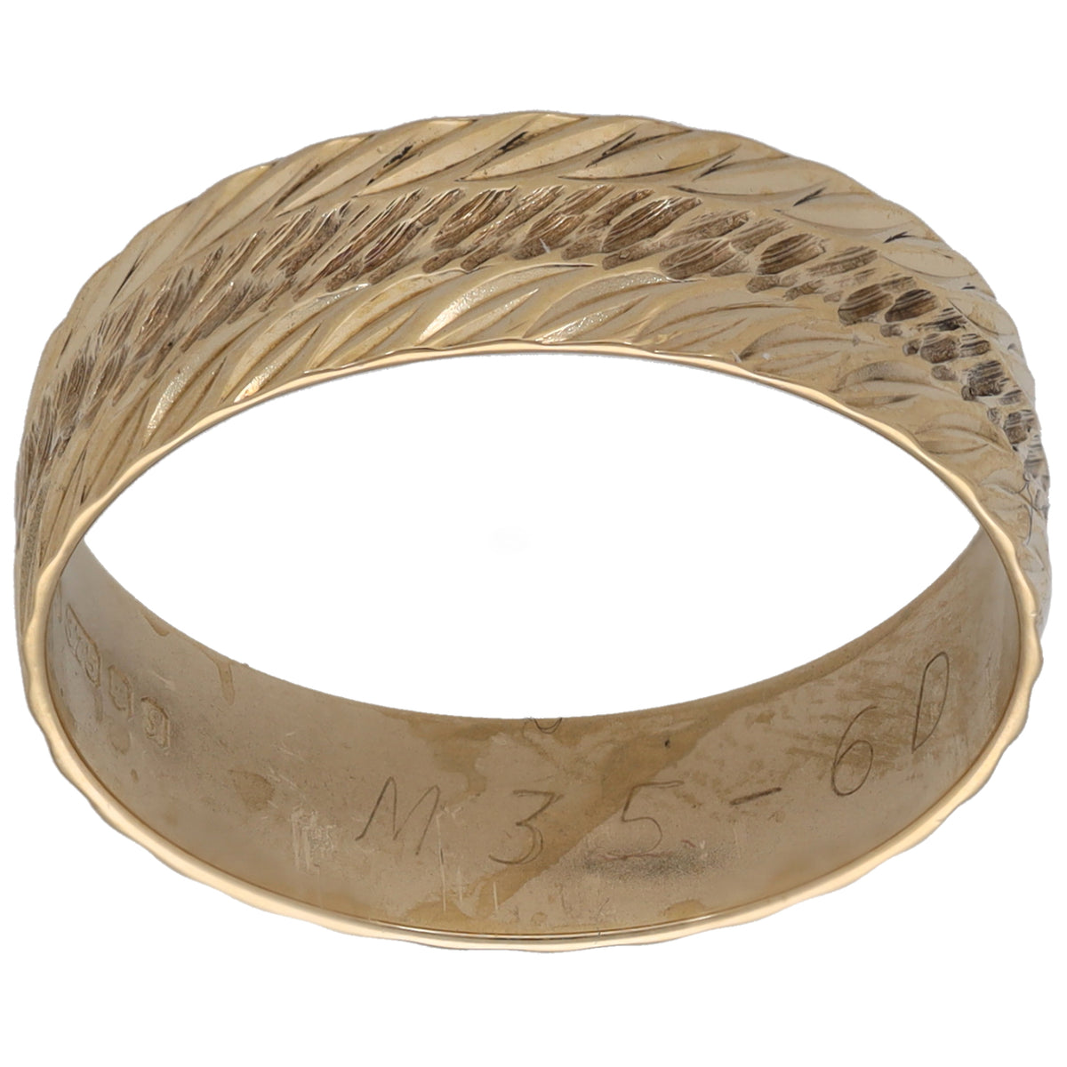 Gold patterned wedding ring with textured leaf pattern, polished band.