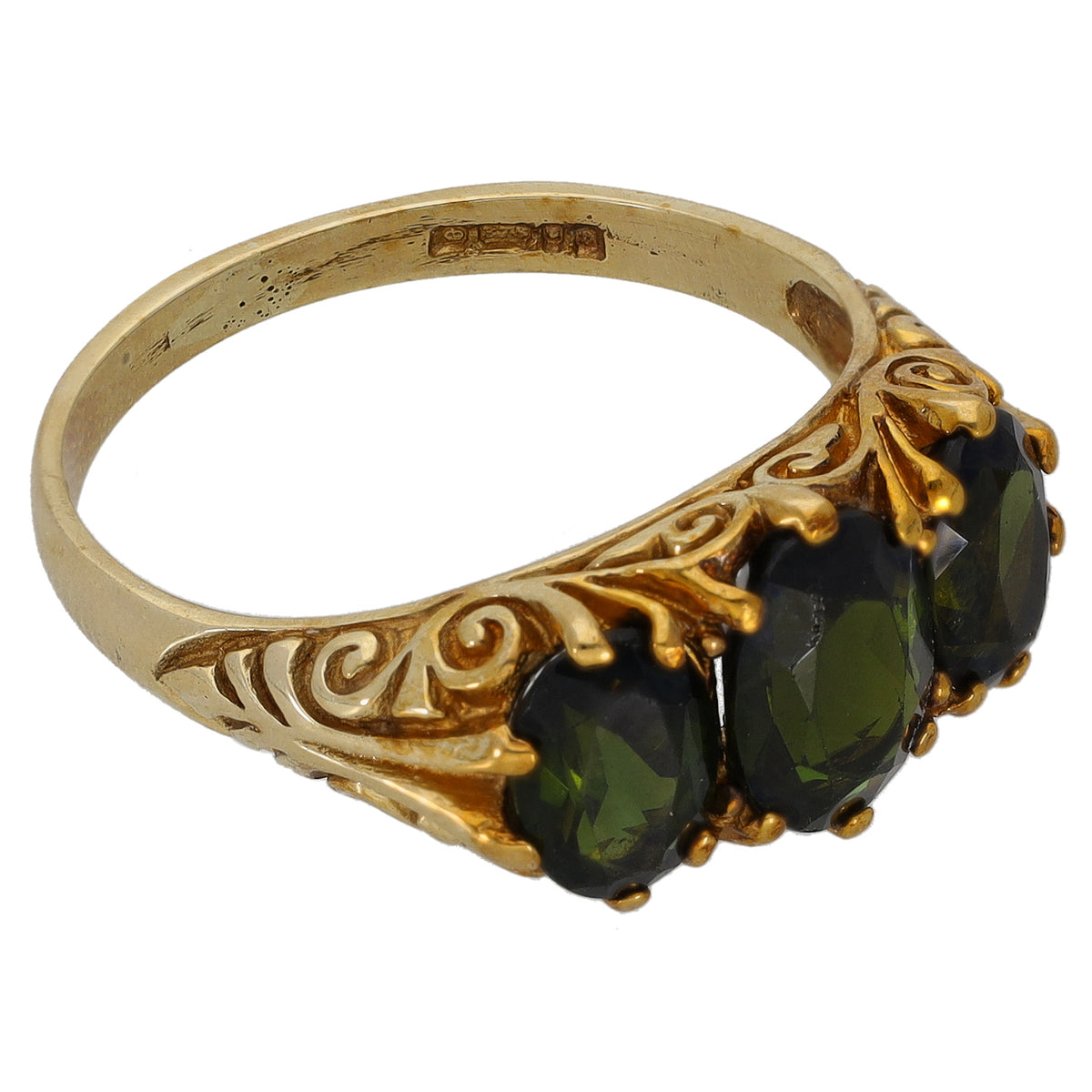 Gold three-stone ring with ornate filigree and three dark green oval gemstones