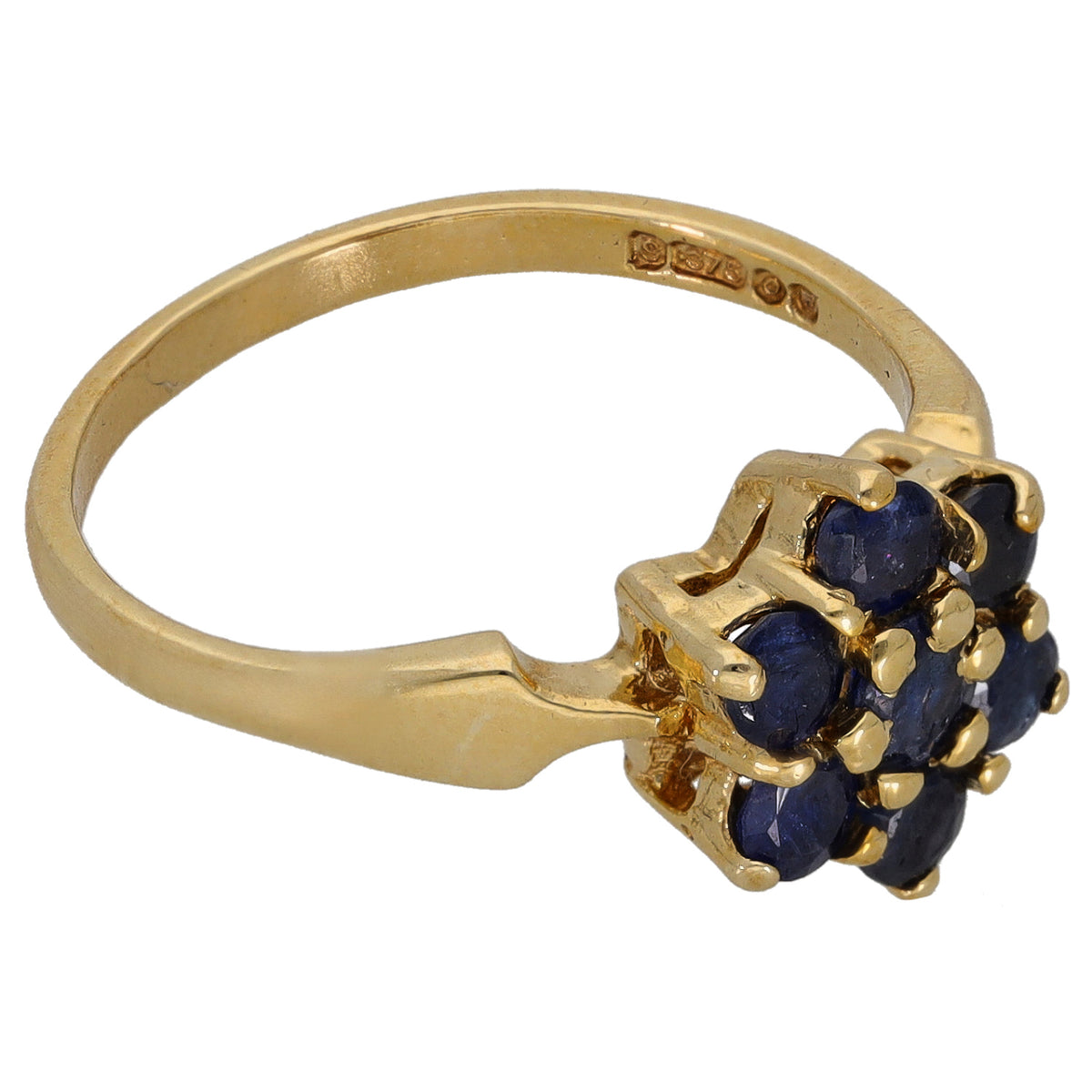 Gold sapphire cocktail ring, side view with dark blue stones and engraved band