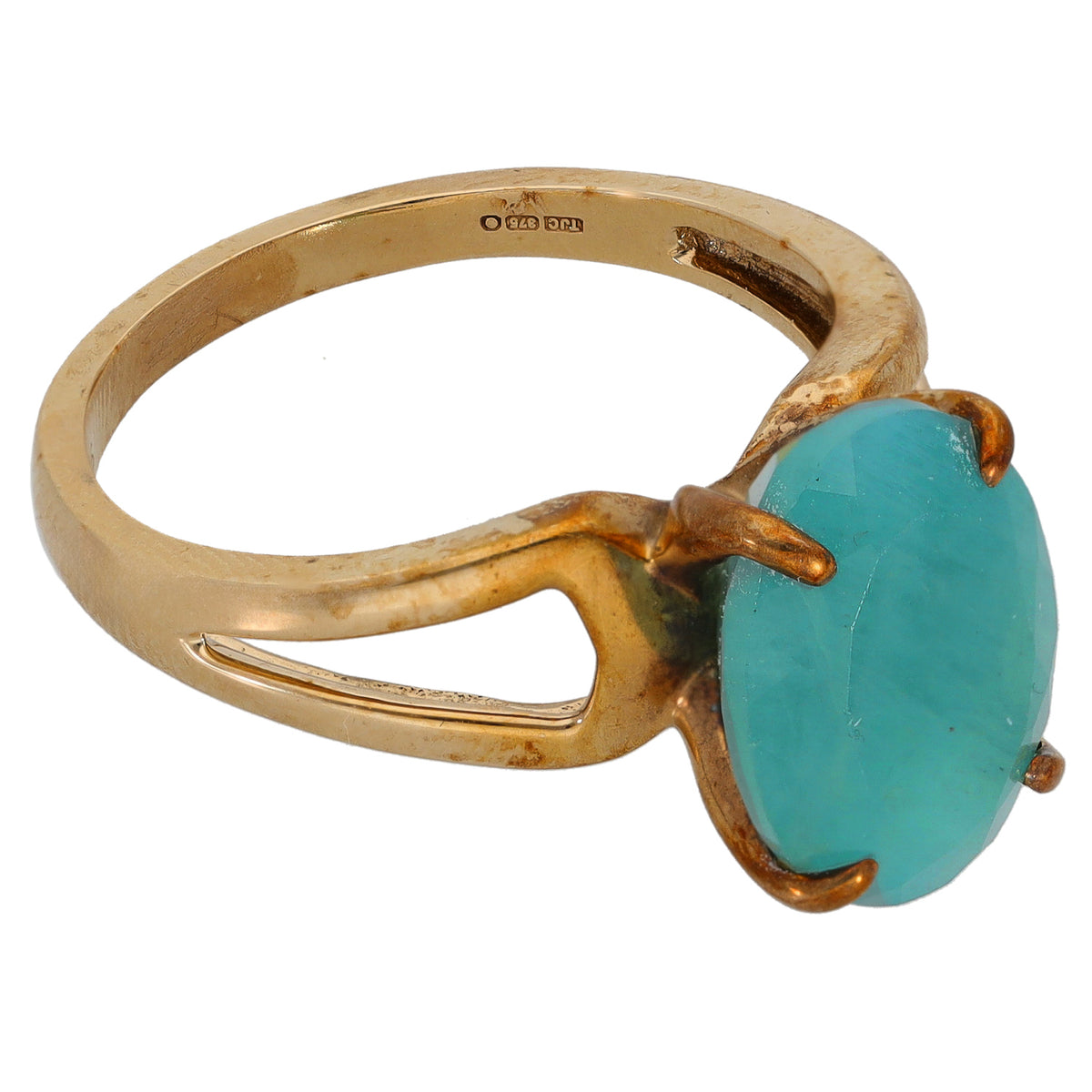 Gold ring with open side band and oval turquoise gemstone, prong claws