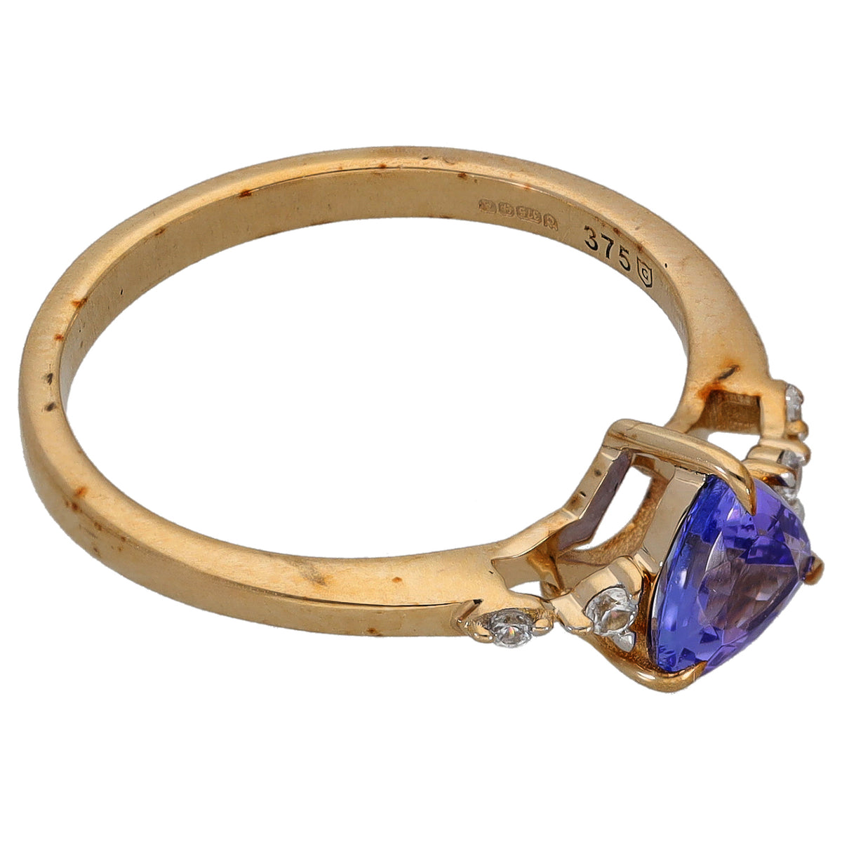 9ct gold ring band with side prongs holding a pear-cut blue center stone and round accents