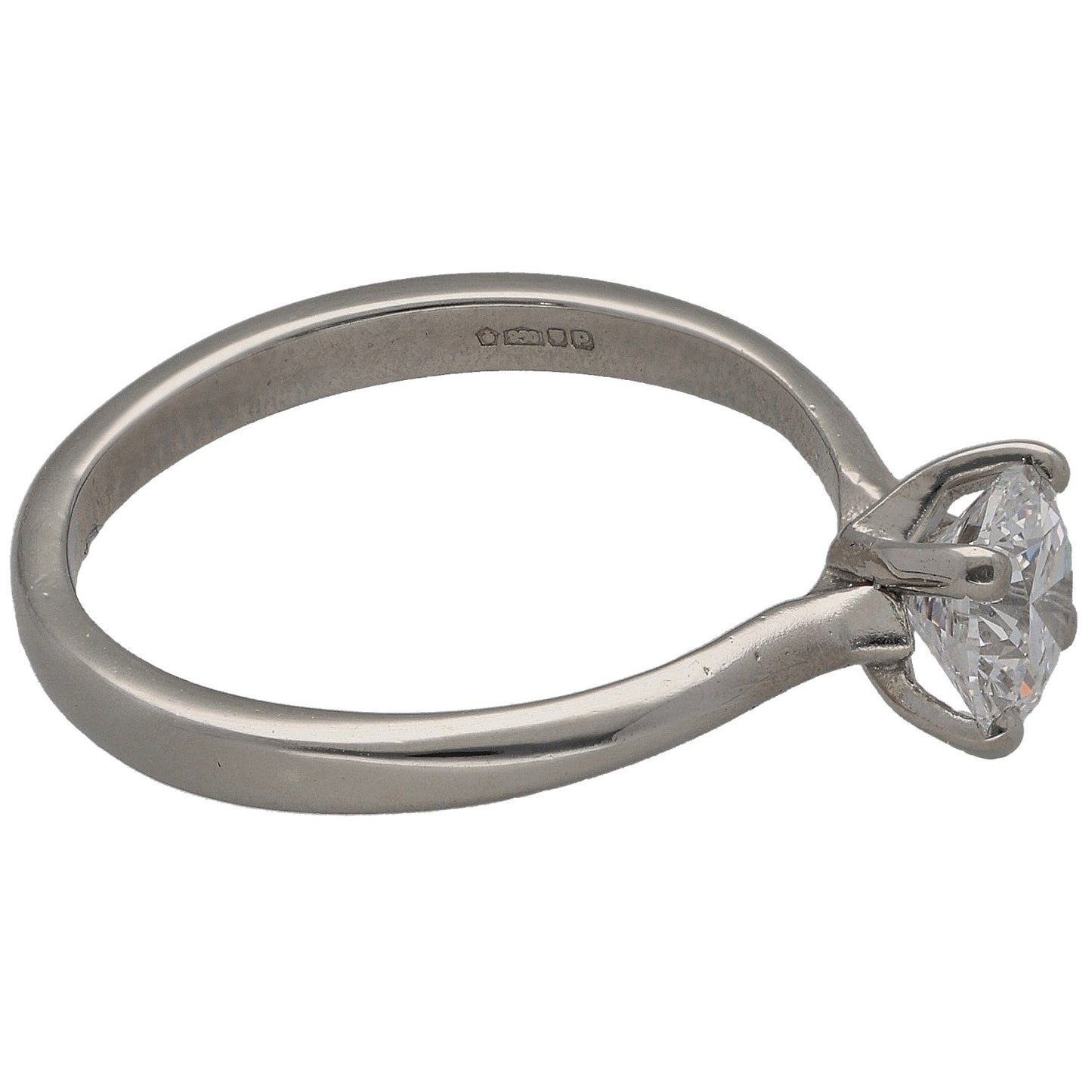 Platinum solitaire ring with side view of round diamond and metal prongs