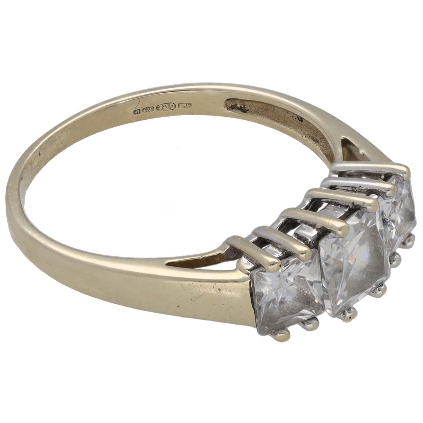 Gold-tone three-stone CZ ring side profile with square-cut stones and prongs