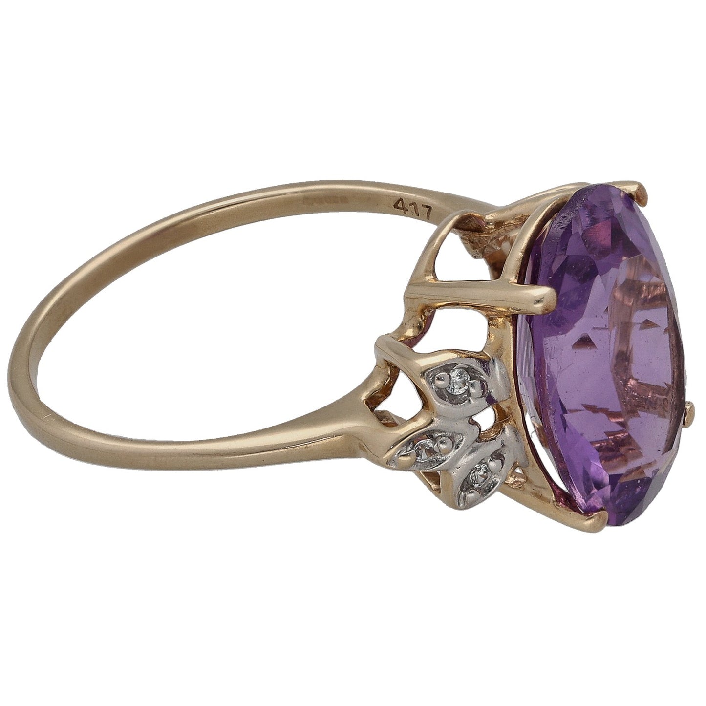 Gold cocktail ring side view with oval purple stone set in prongs and small clear gems