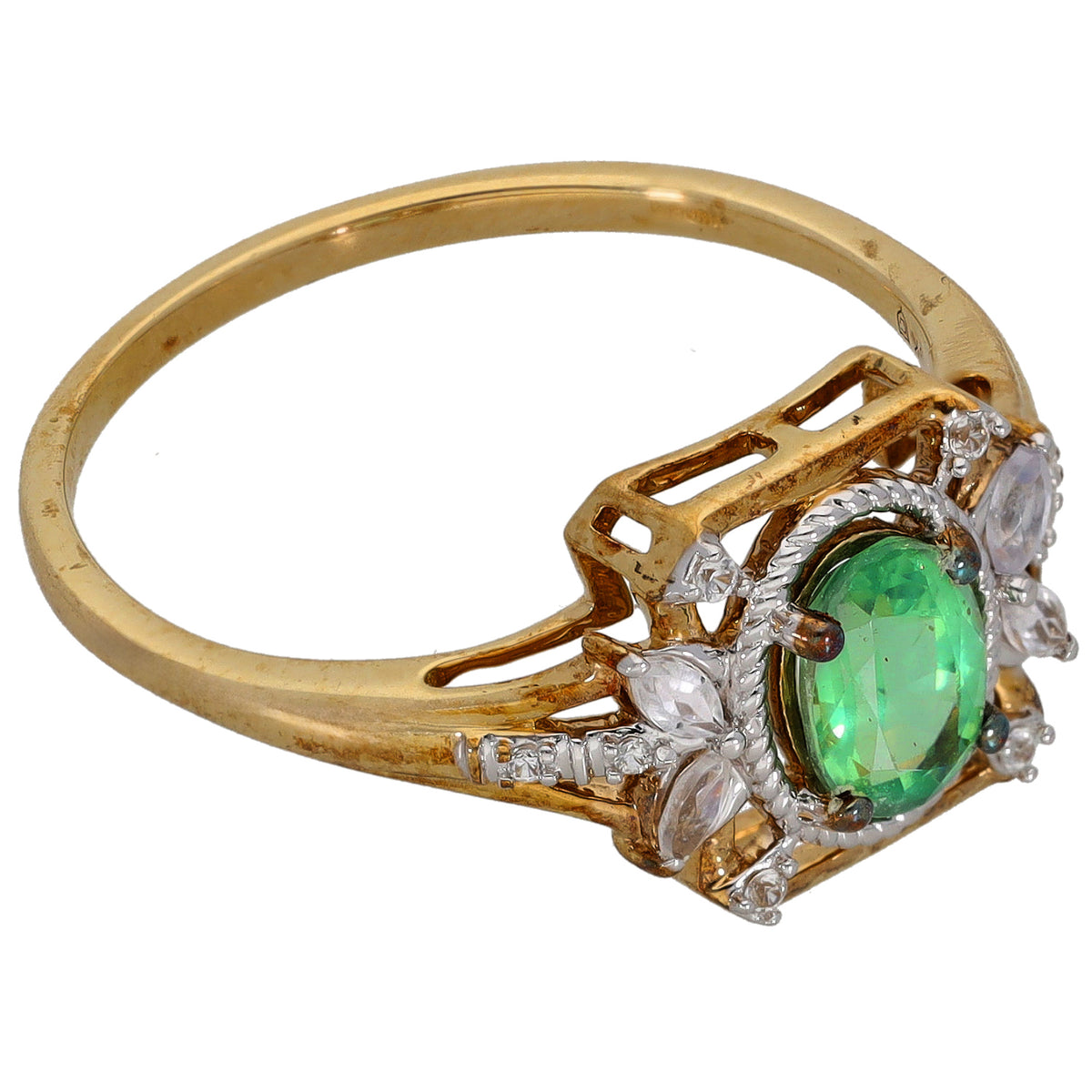 Gold cocktail ring with green oval center stone and clear stone side setting