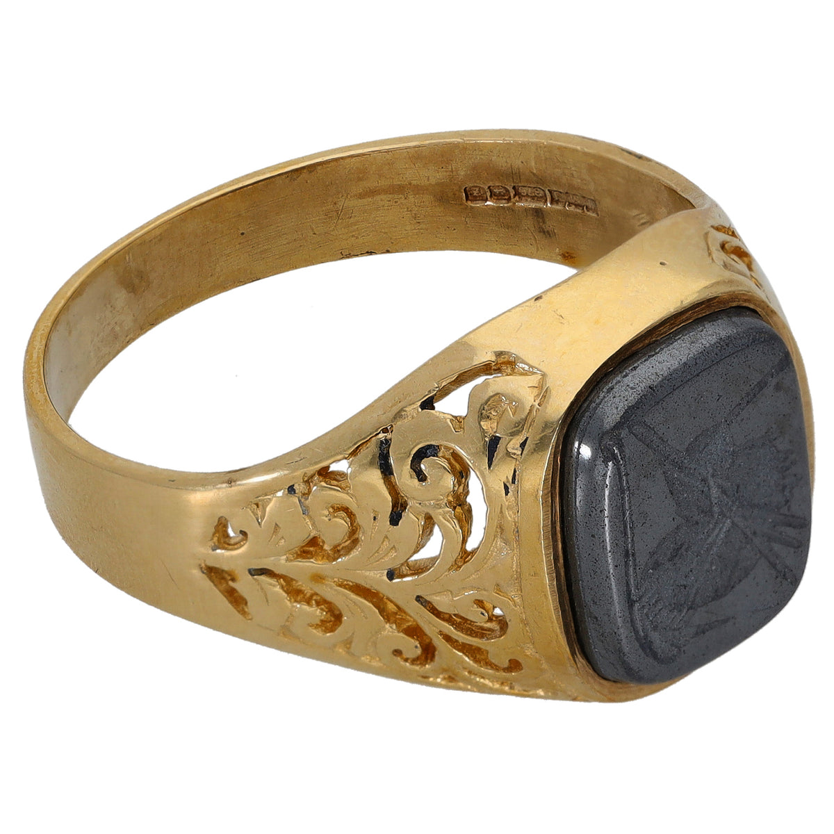 Gold signet ring angled view, oval dark hematite stone with etched side scrolls
