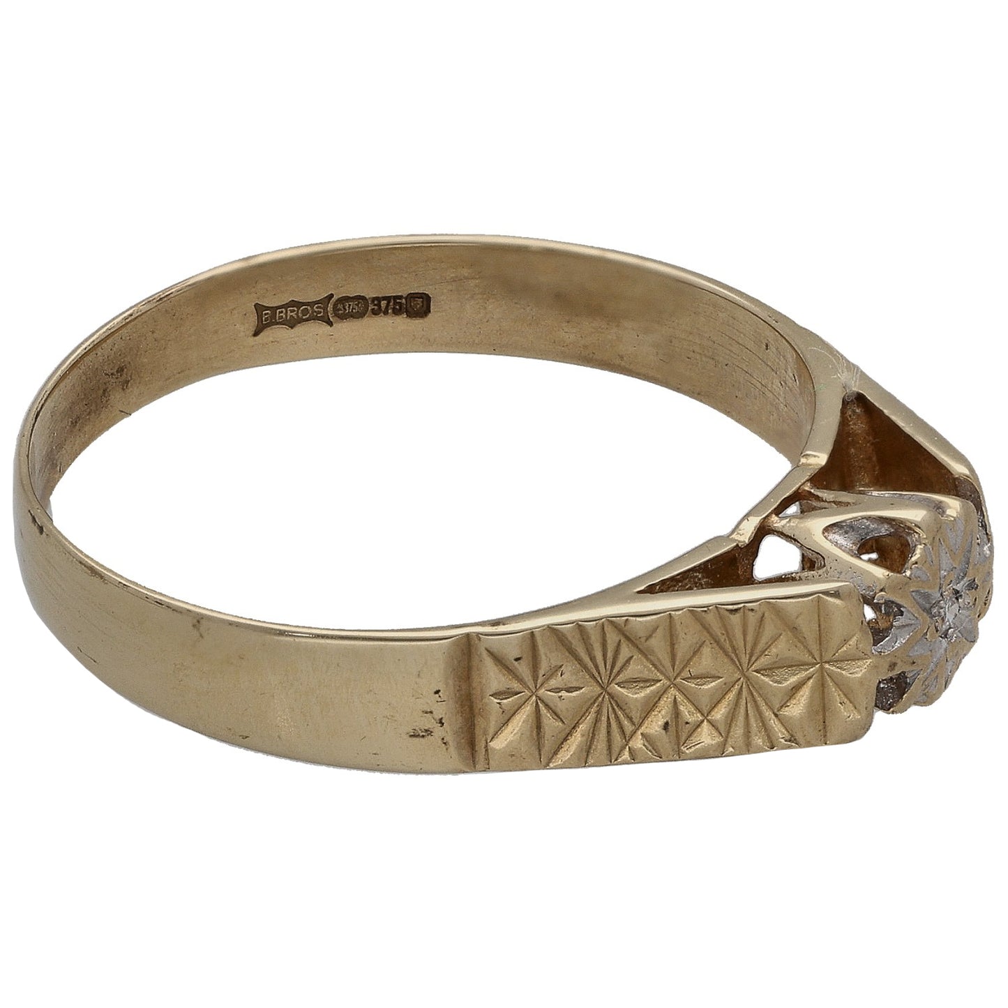 Gold ring with geometric textured band and round diamond solitaire setting