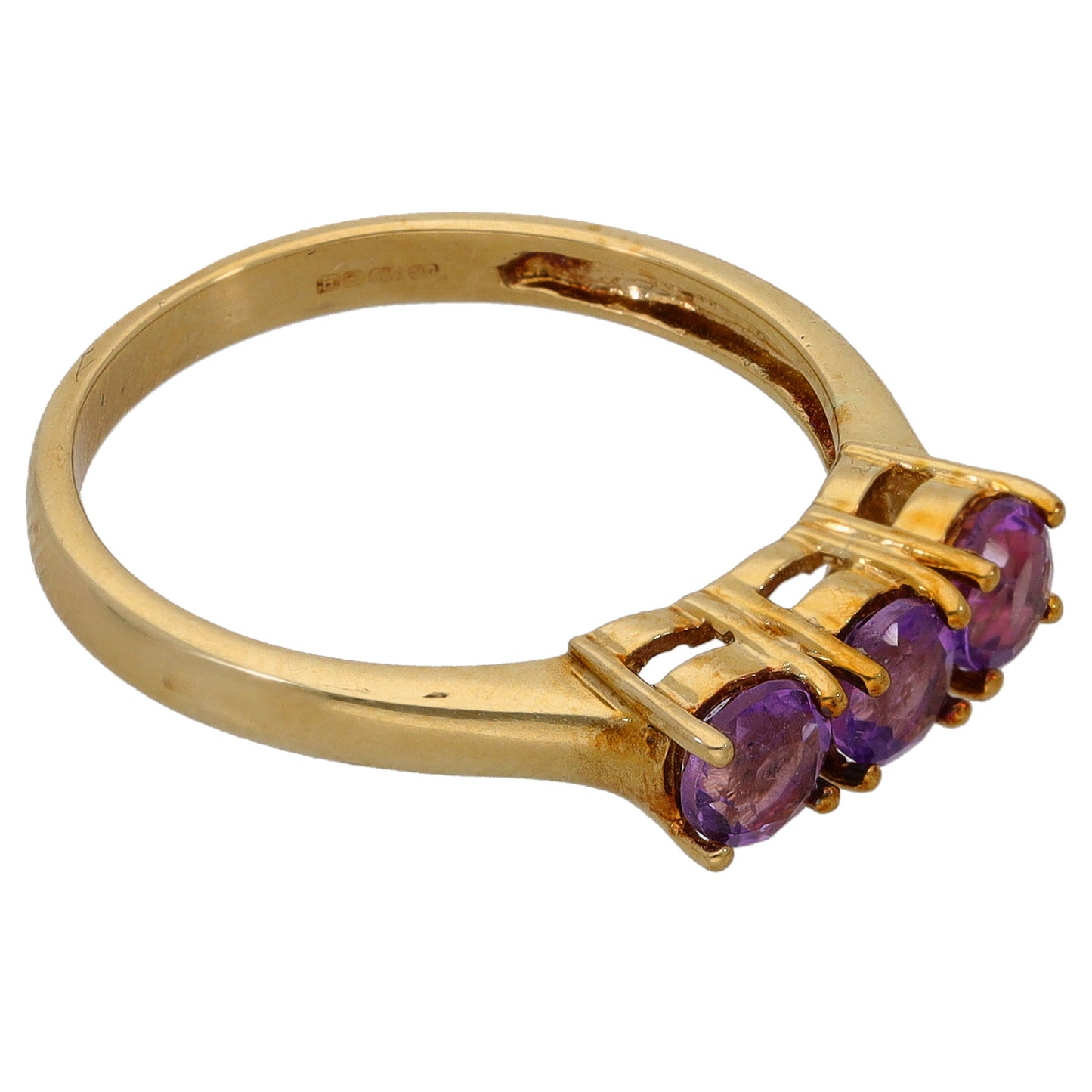 Gold amethyst three-stone ring side view, showing raised purple stones on band
