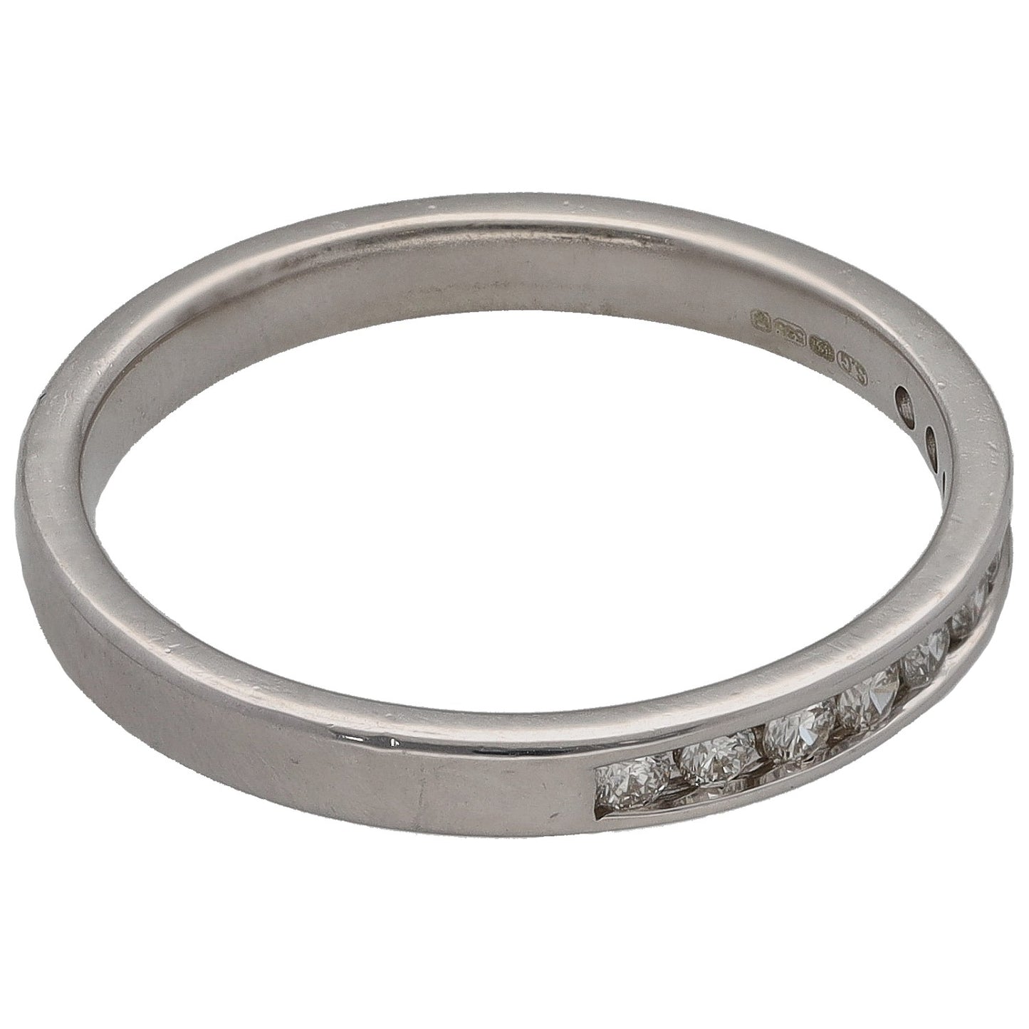 White gold half-eternity ring with round diamonds and visible inside hallmark.