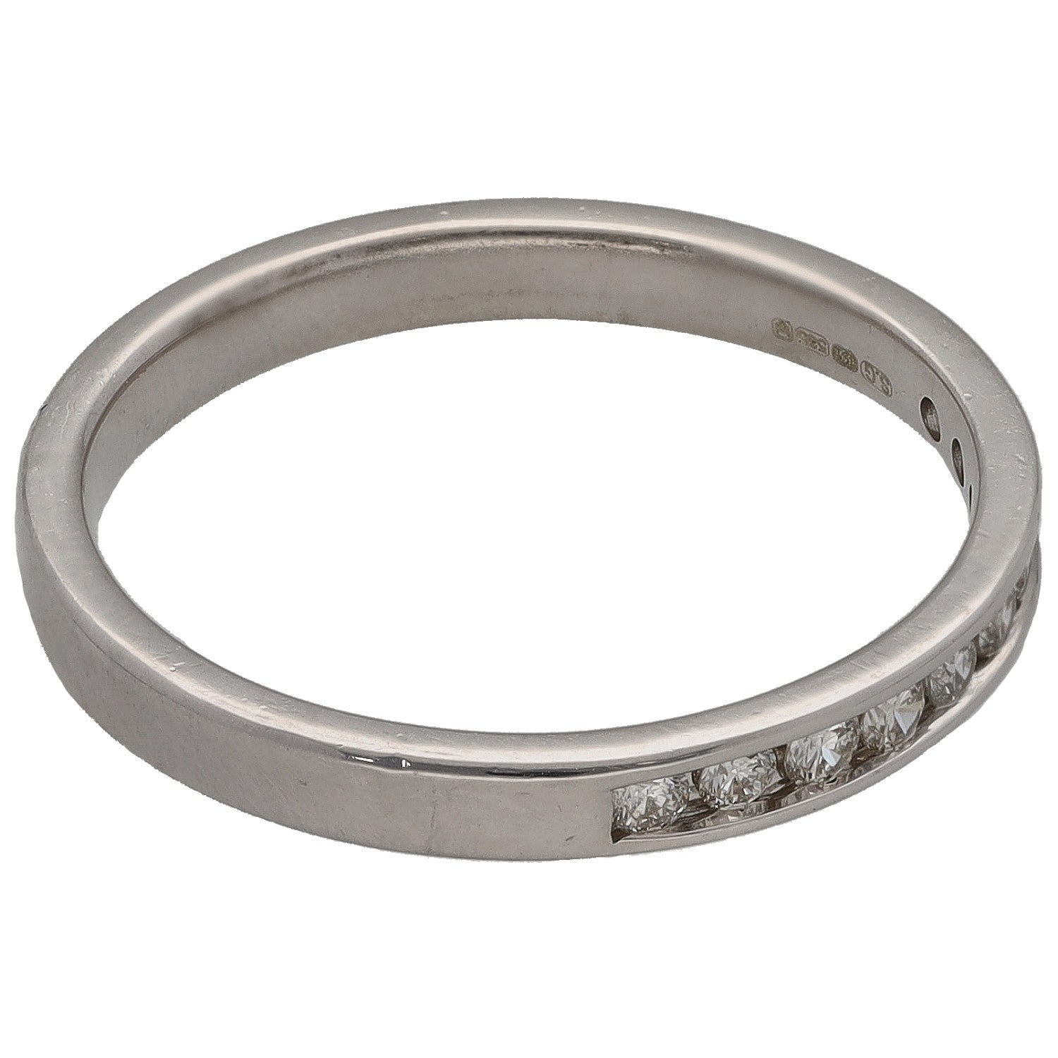 White gold half-eternity ring with round diamonds and visible inside hallmark.