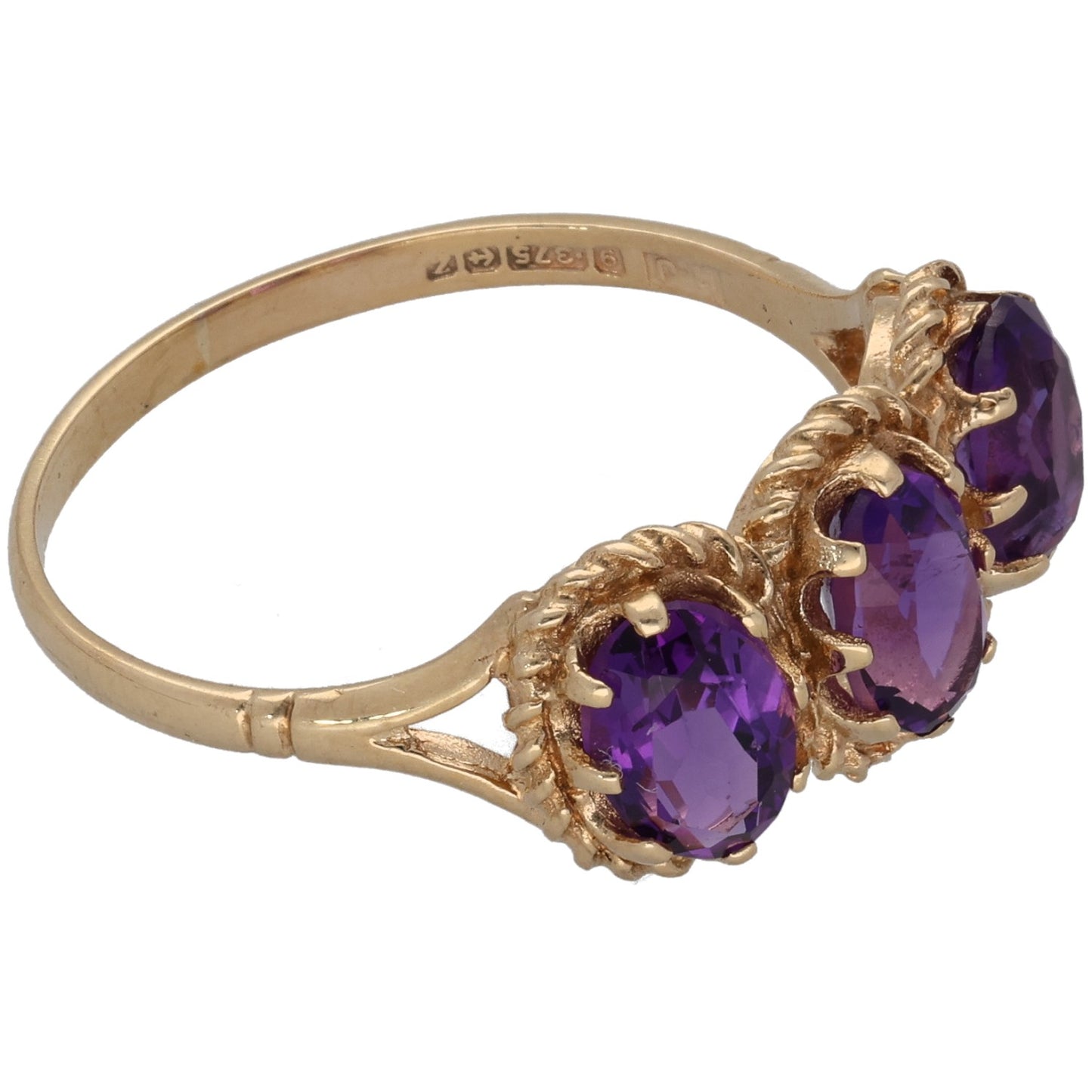 Hallmarked gold band with three purple oval amethyst stones, side profile
