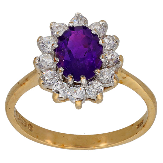 Gold cocktail ring with round purple amethyst center and halo of clear cubic zirconia