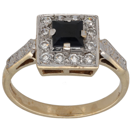 Gold dress ring with square black center stone and clear gem border, size Q