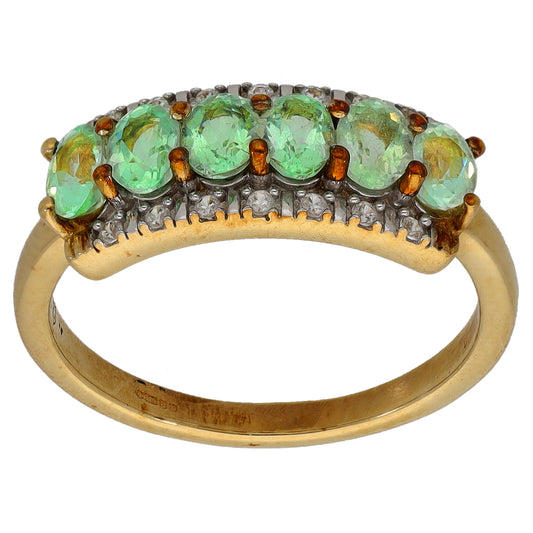 9ct gold cocktail ring, top view: row of green oval stones in silver-toned setting