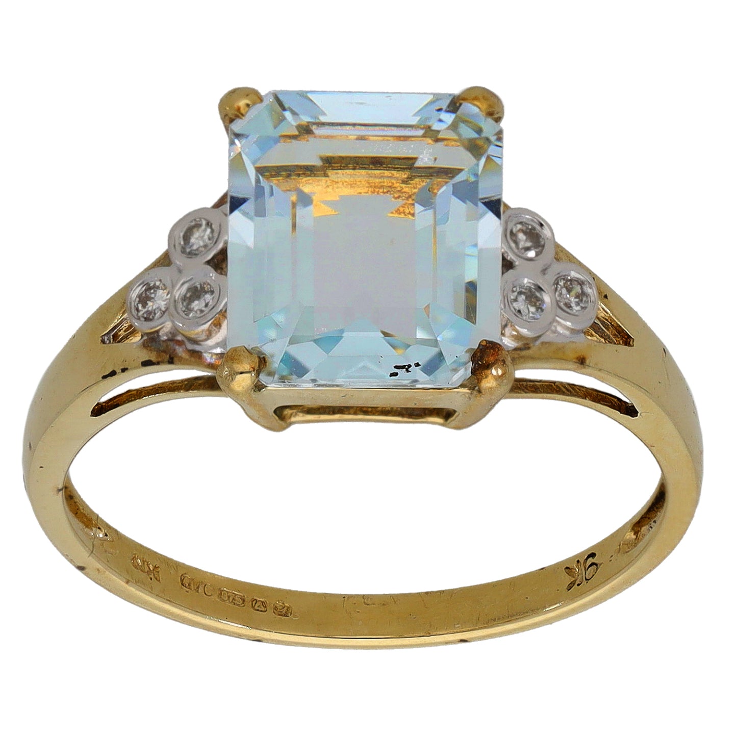 Gold ring featuring rectangular aquamarine center with round diamonds on both sides