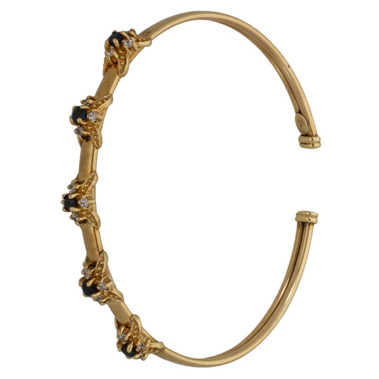 9ct gold torque bangle with dark blue and clear stone clusters