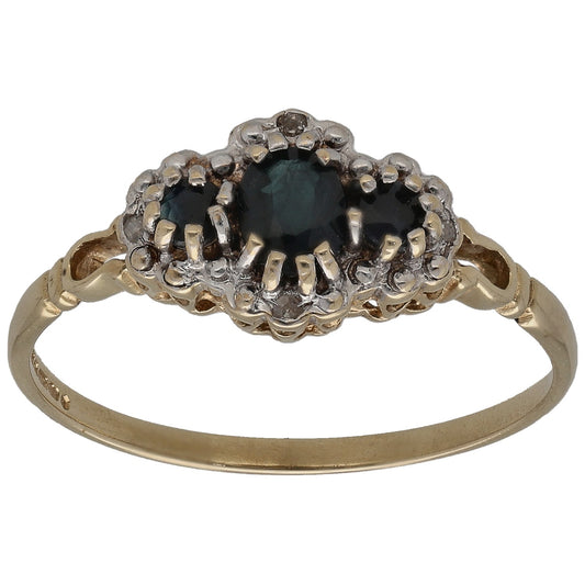 9ct gold cluster ring with dark gemstone center and round diamond accents, prong set