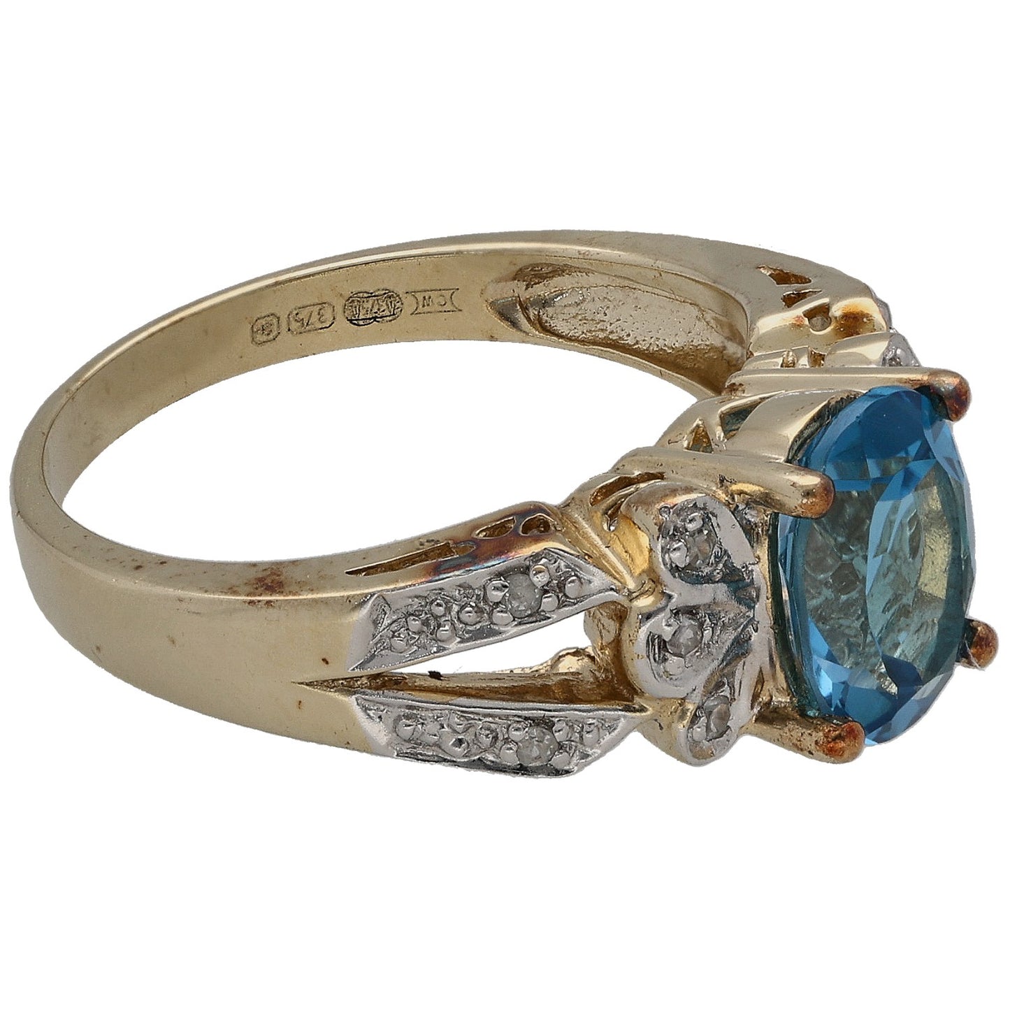 9ct gold ring side view, blue topaz bezel with diamond details and engraved hallmarks