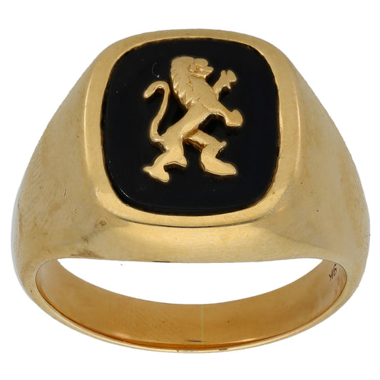 Gold signet ring with black onyx inset and gold crest emblem, front view