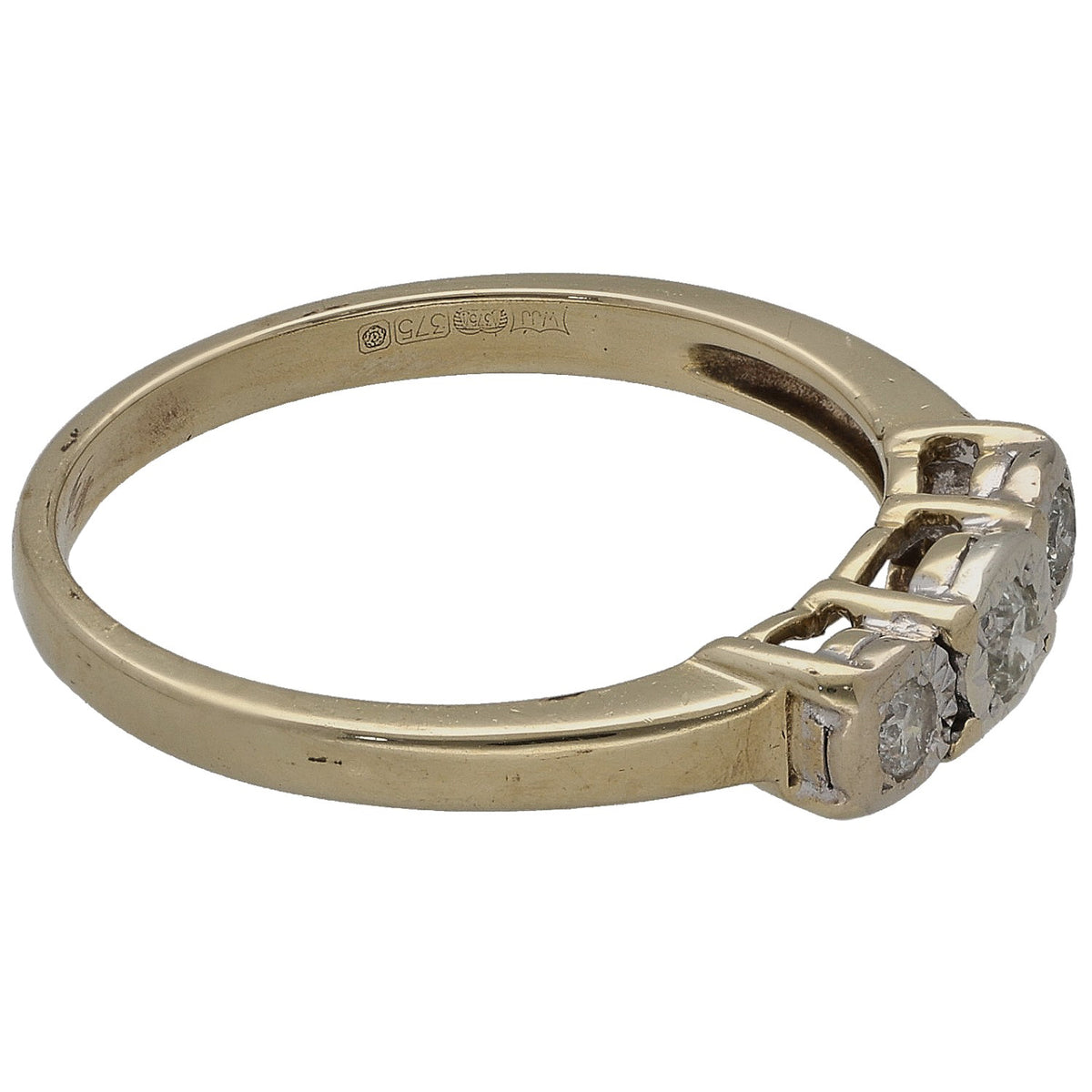 Yellow gold three-stone ring with a round diamond cluster on the side profile