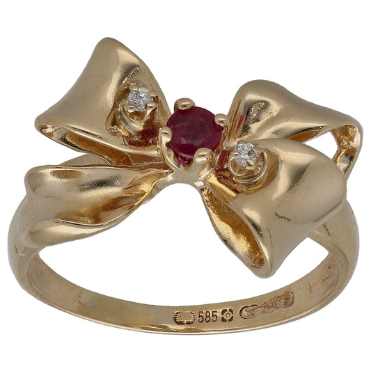 Gold cocktail ring with marquise bow, ruby center, and round diamond accents