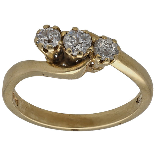 Gold three-stone ring with round prong-set diamond trio, side view