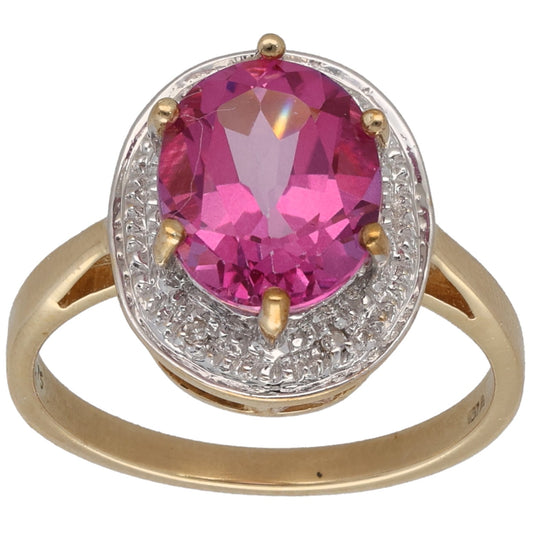Gold-coated cocktail ring with oval pink topaz and small round diamond accents