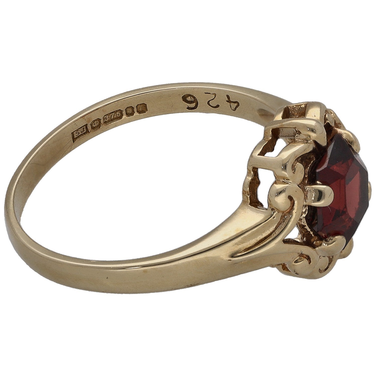 Gold ring with dark red garnet setting and engraved inner band