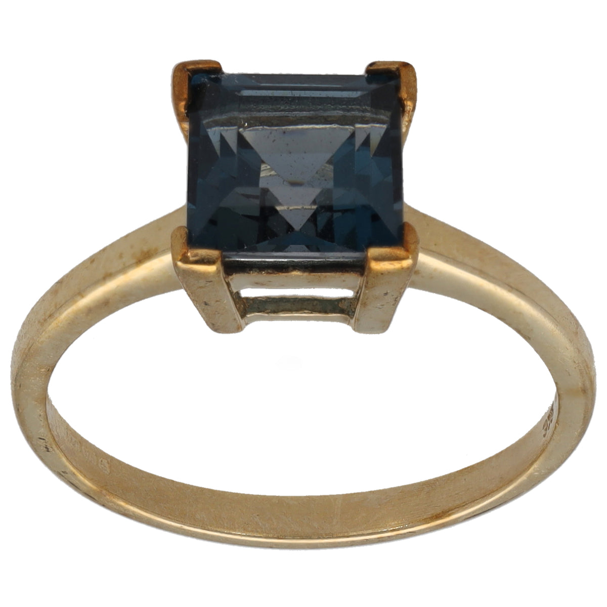 Gold ring with square dark blue gemstone in four-prong setting
