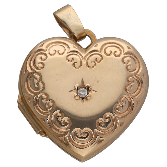 Gold heart locket pendant with engraved scrollwork and central round diamond