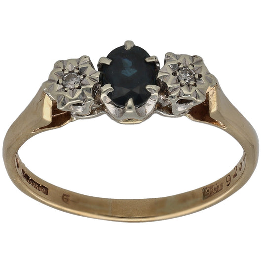 9ct gold three-stone ring with dark round sapphire and two round diamond accents