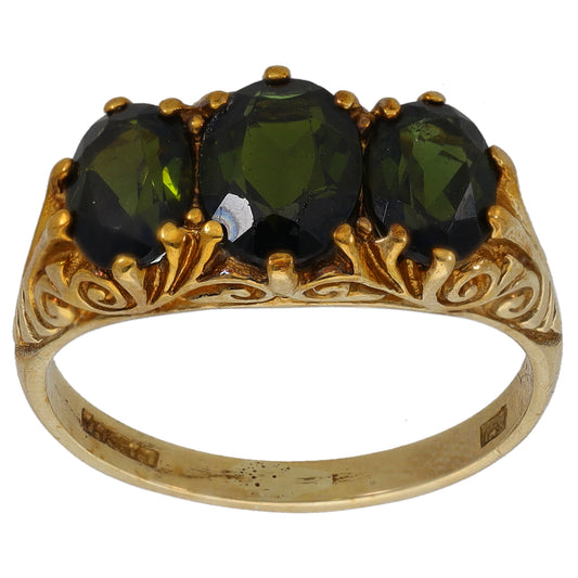 Gold three-stone ring, front view, three dark green oval gemstones in crown setting