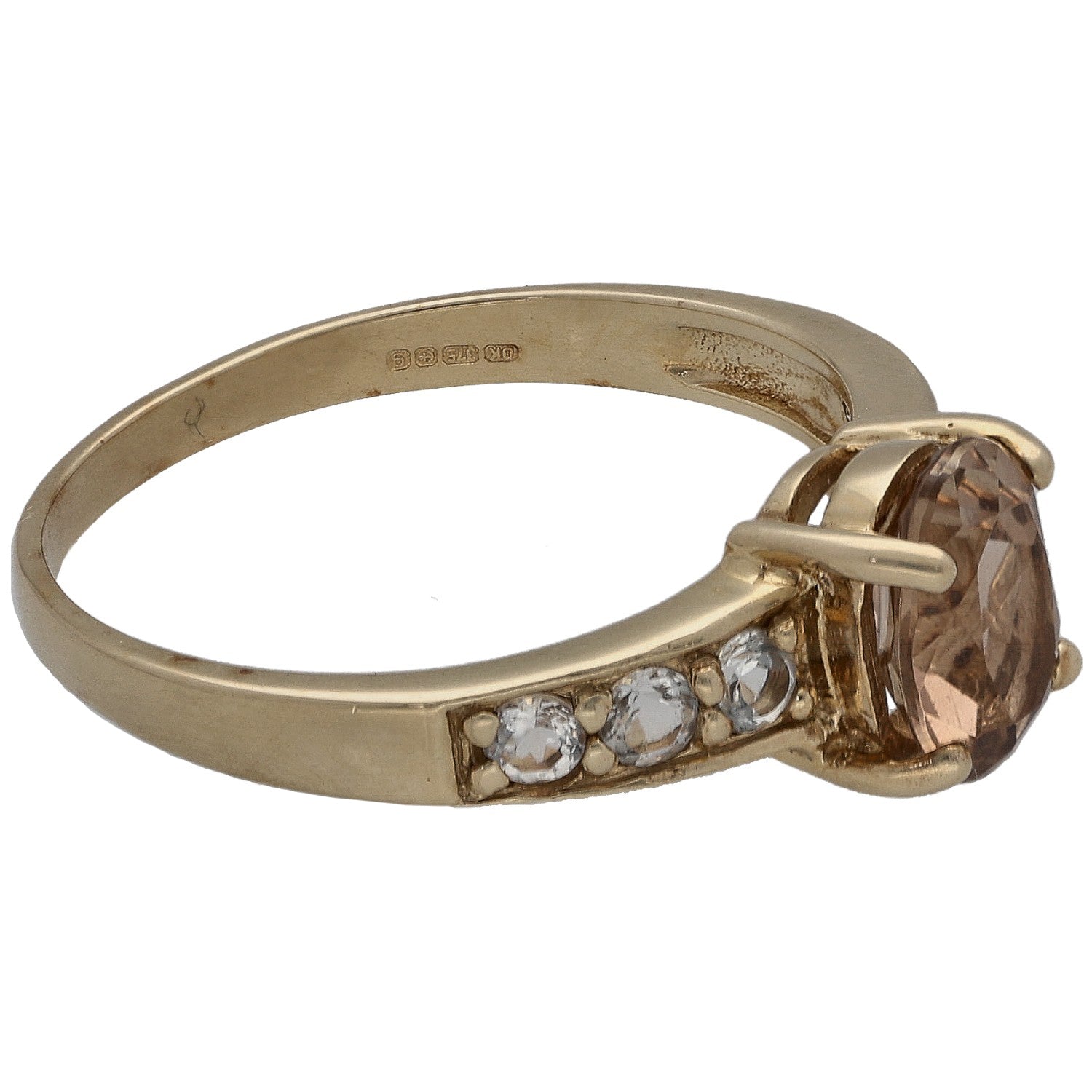 Gold-tone ring with oval smoky stone set to the side; band has small clear stones
