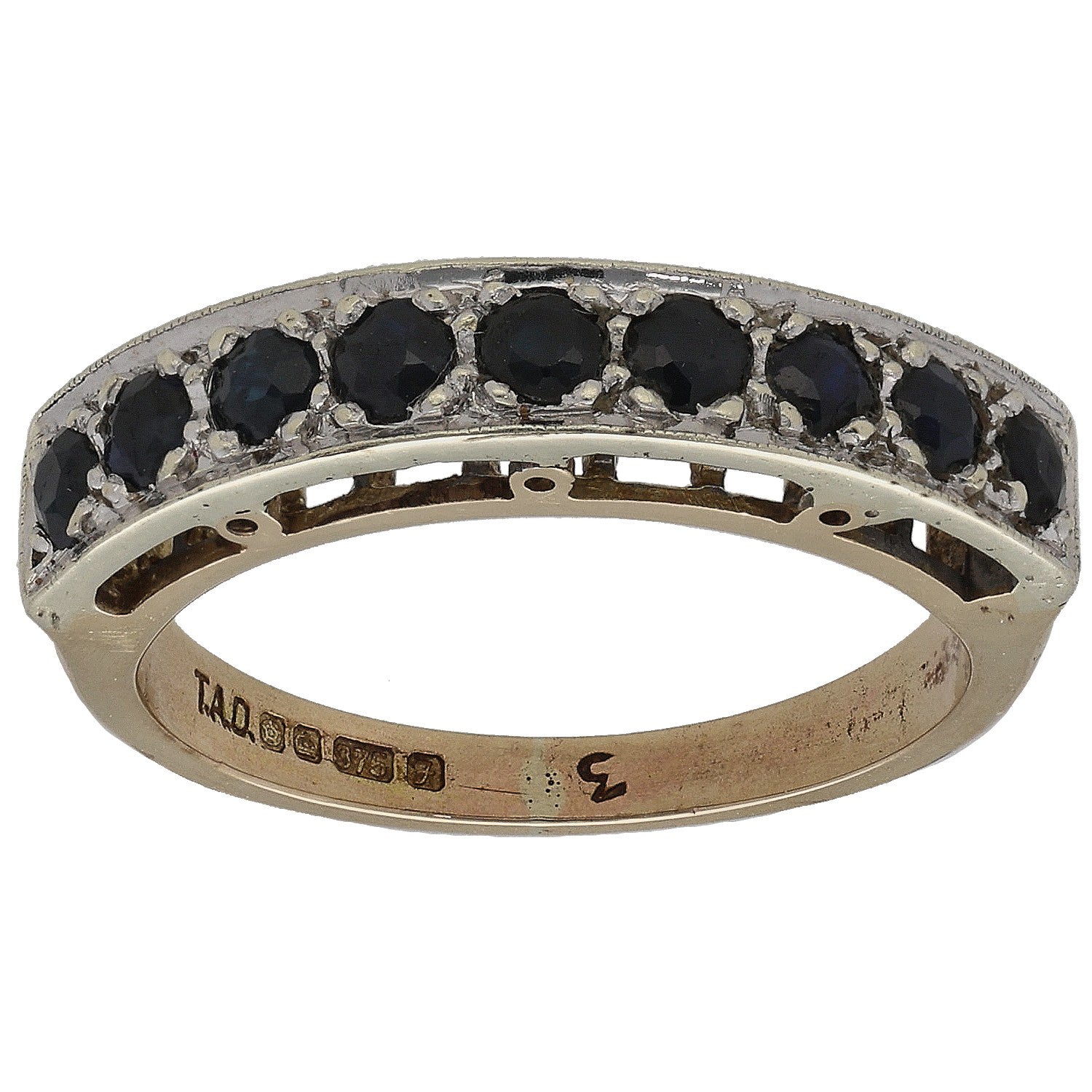 9ct gold half eternity ring with dark round gemstones around the top edge