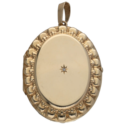 Gold oval locket pendant with raised patterned border and small star detail on front