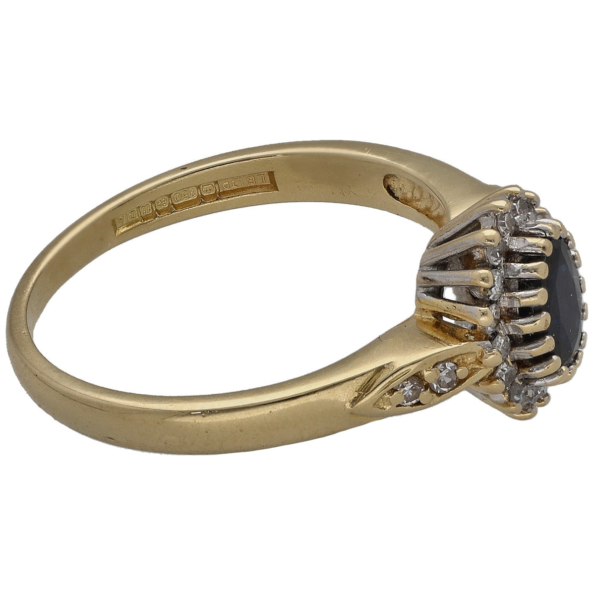 Gold dress ring side view with dark stone bezel and diamond cluster shoulders