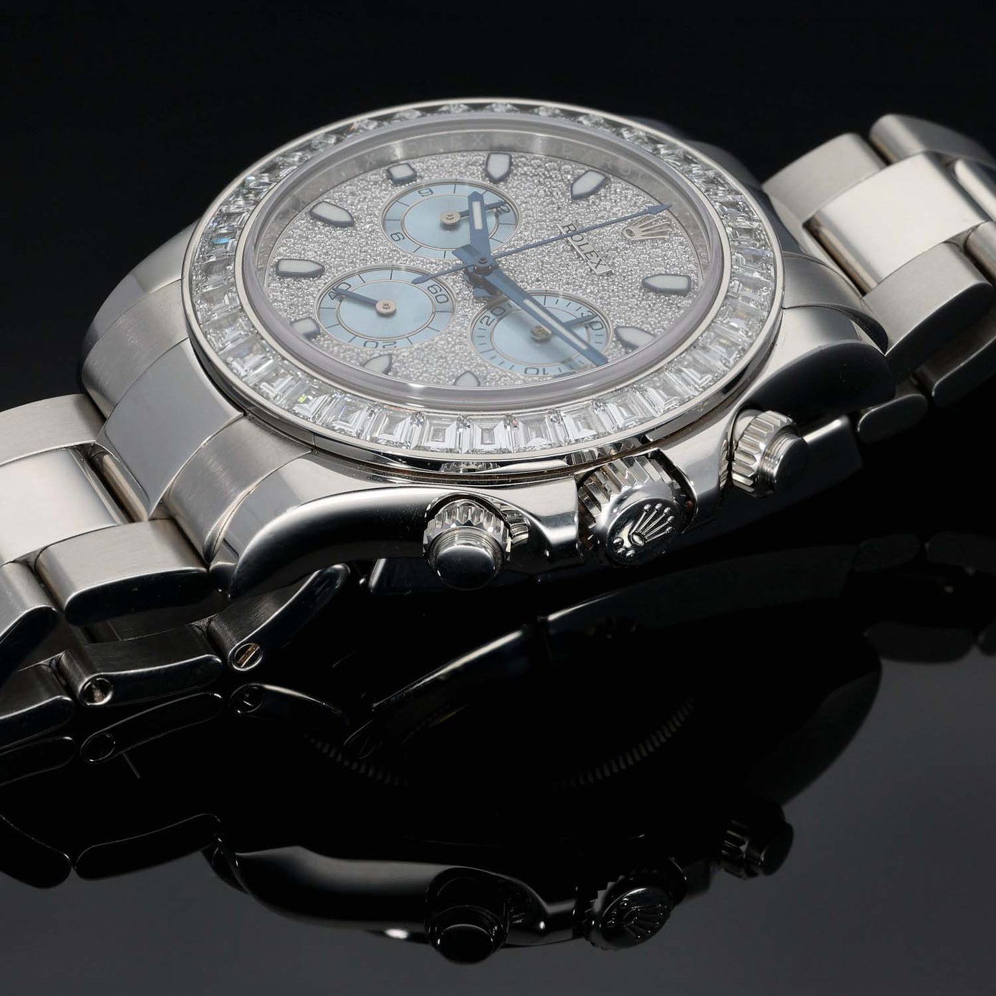 Platinum Rolex chronograph watch close-up with light blue dial and diamond bezel