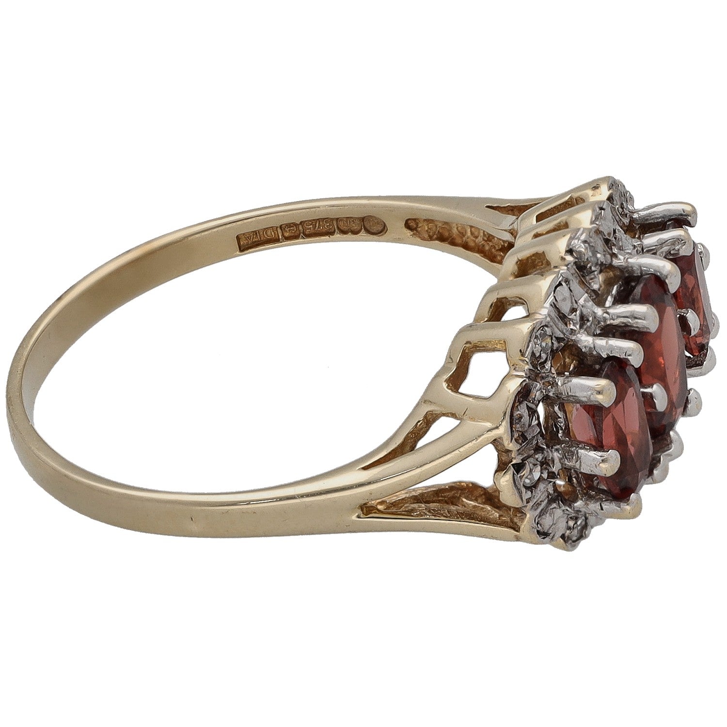 Side view of gold ring with red garnet marquise cluster and diamond halo prongs