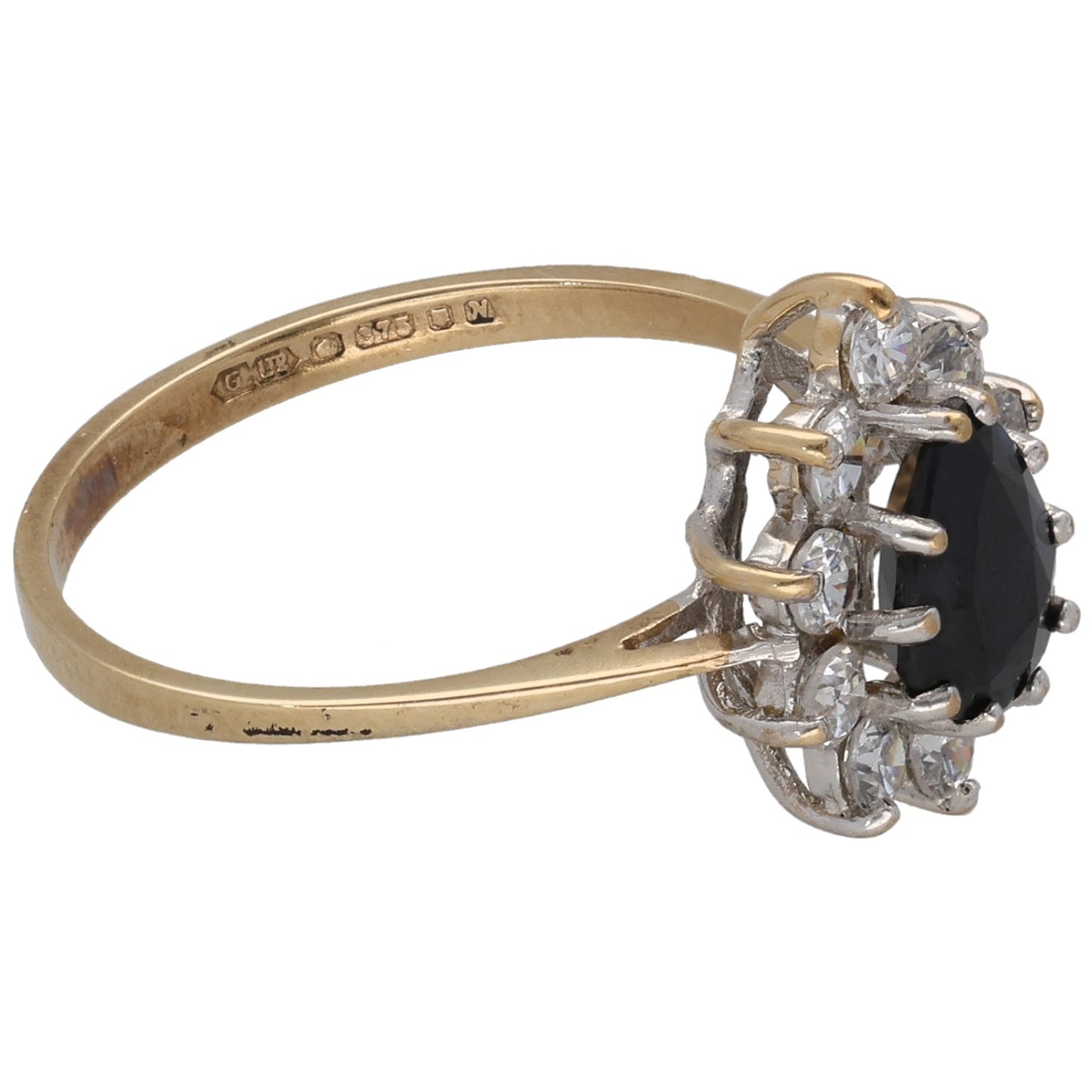 9ct gold ring with dark oval gemstone set in clear stone prongs