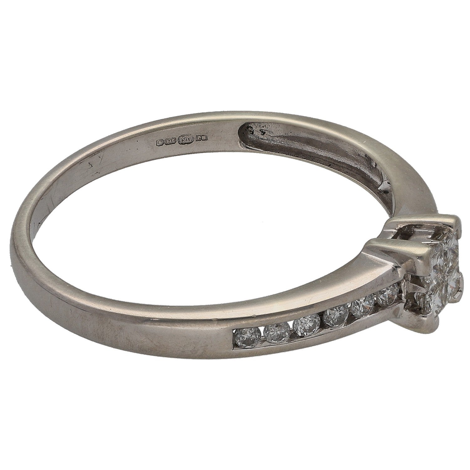 White gold diamond ring side view with princess center and curved row stones